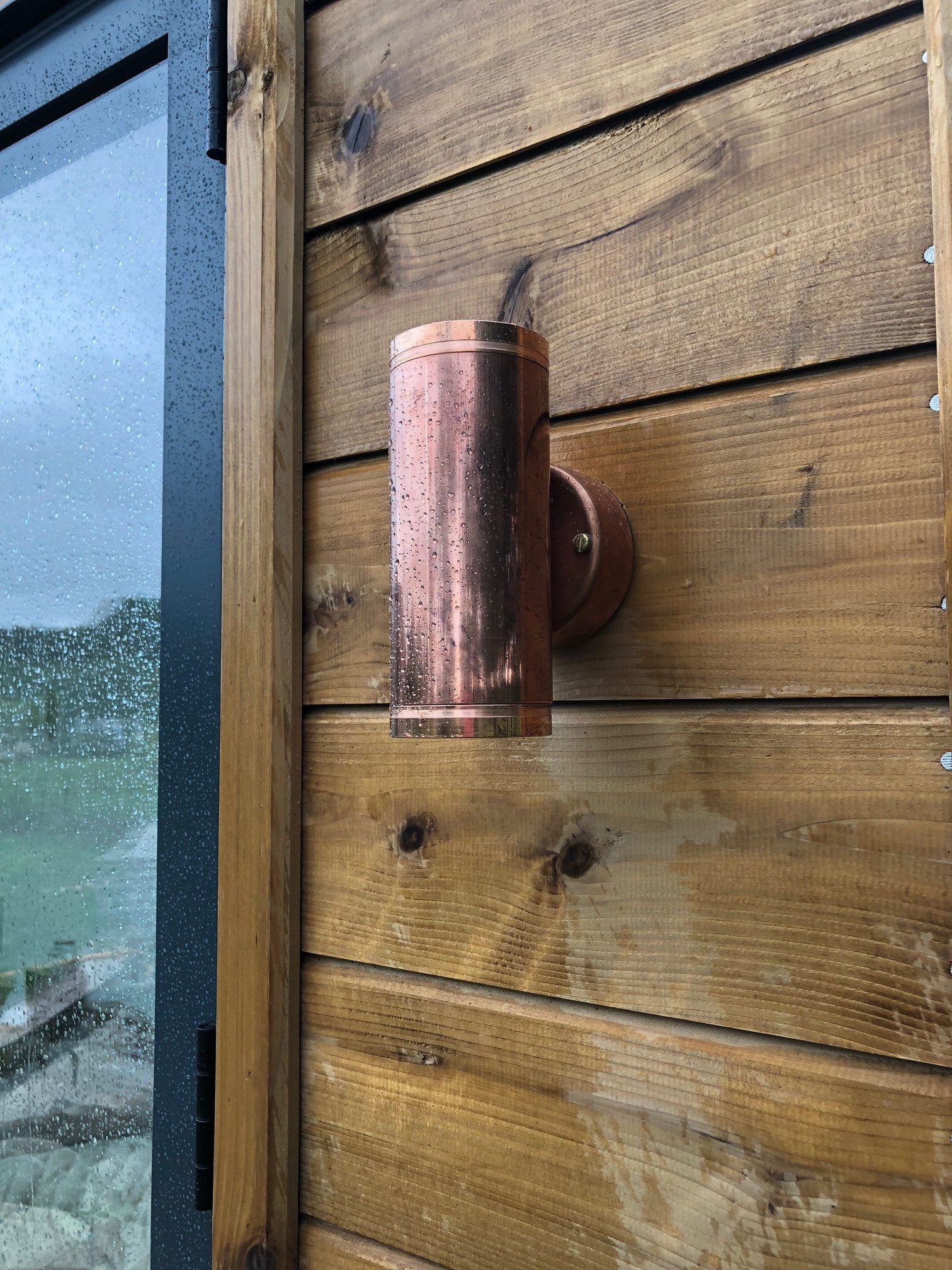 Hunza copper light installed on wooden building